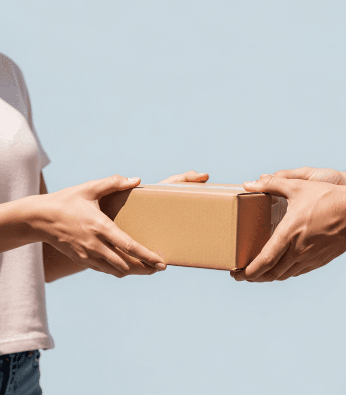 Hands handing over a wrapped delivery parcel