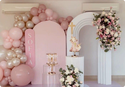 A pastel floral balloon arch event setup